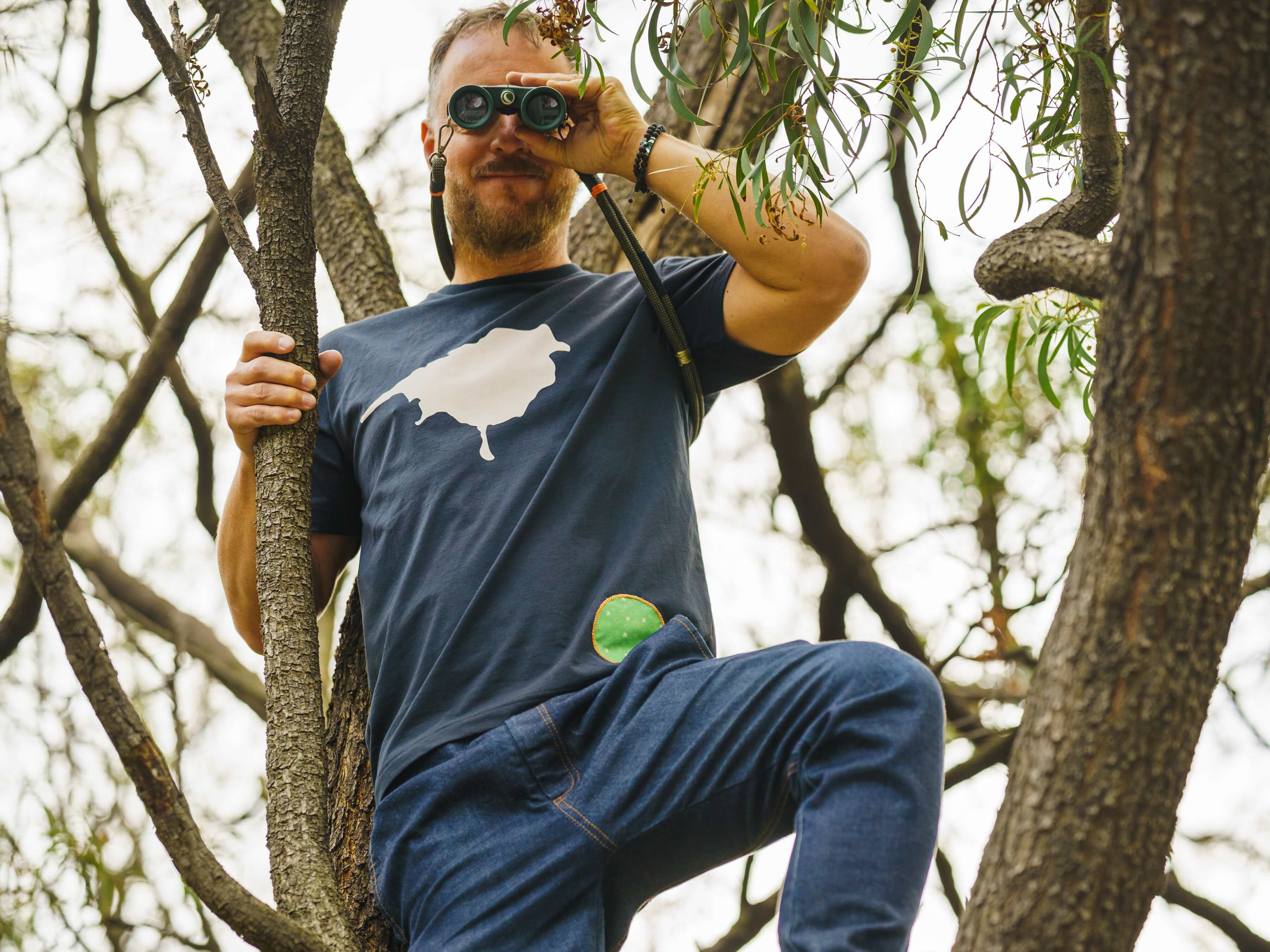 model in a tree wearing a lyfer birdmark tee