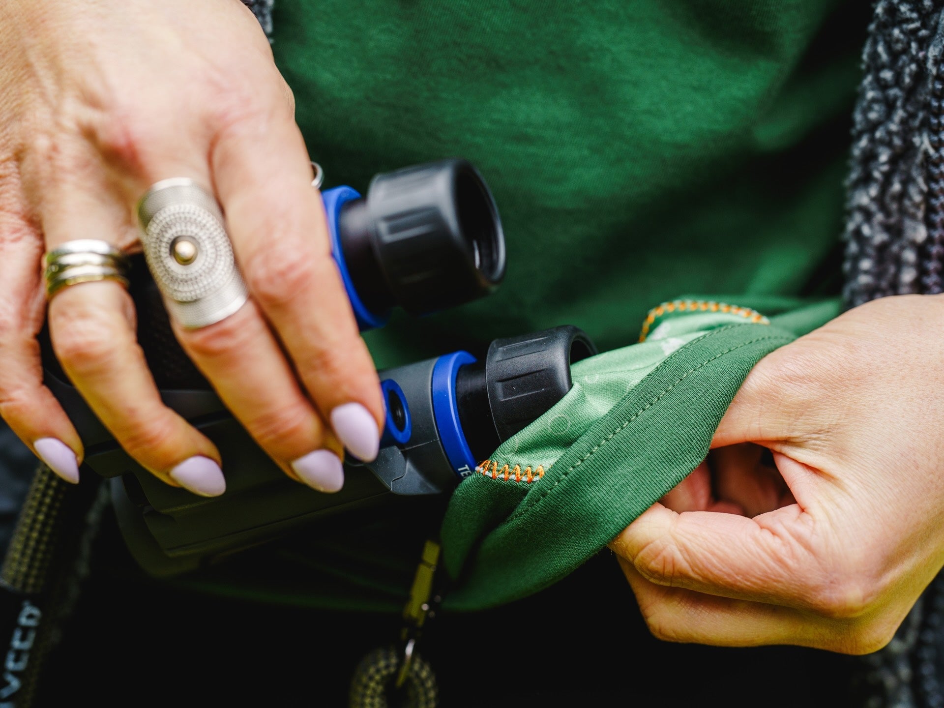 Lyfer BRAND tee with microcloth with binoculars being cleaned