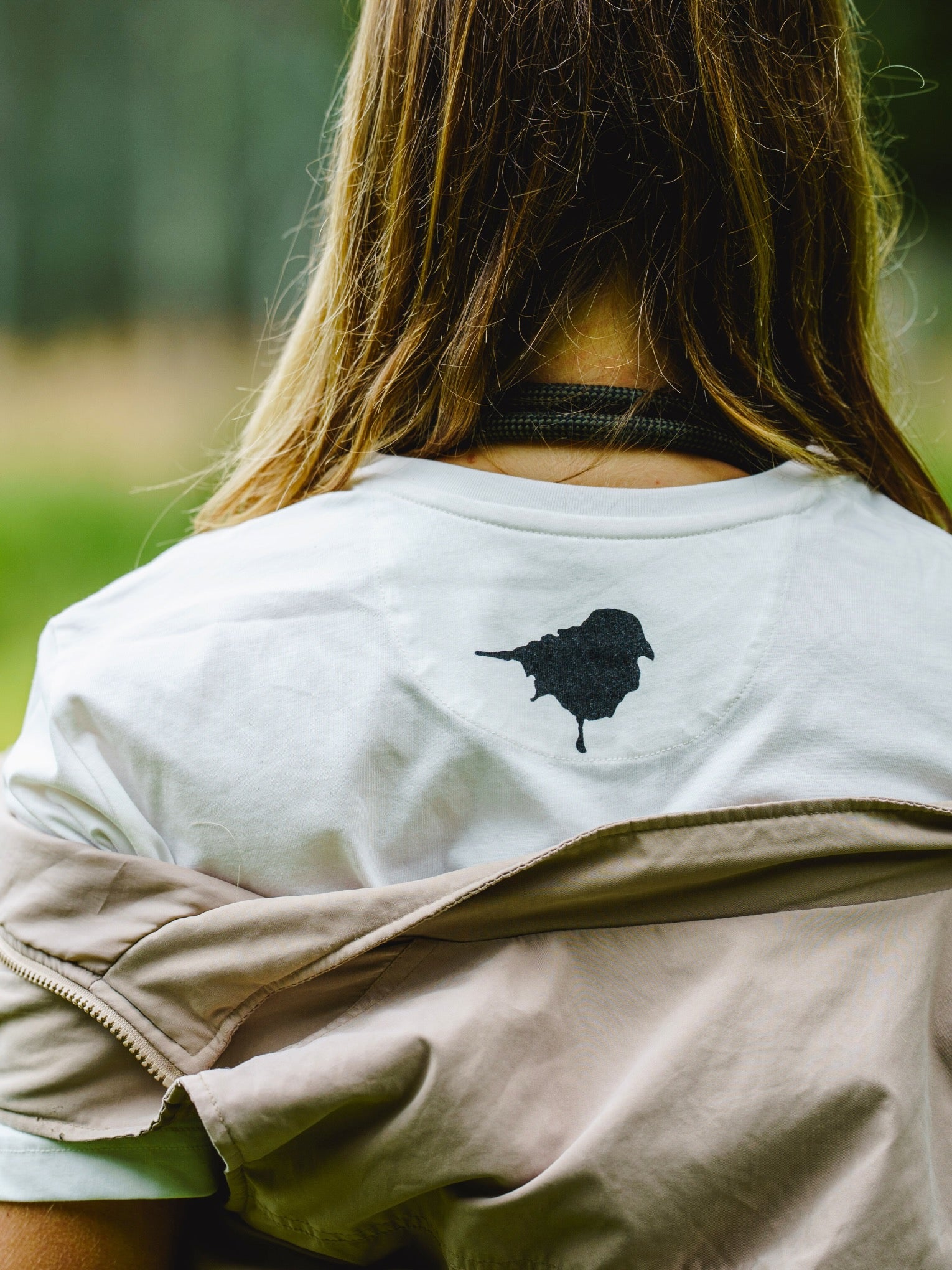 Bird Original Tee worn by Birder model showing the birdmark lyfer logo on the back and the quality of tee.