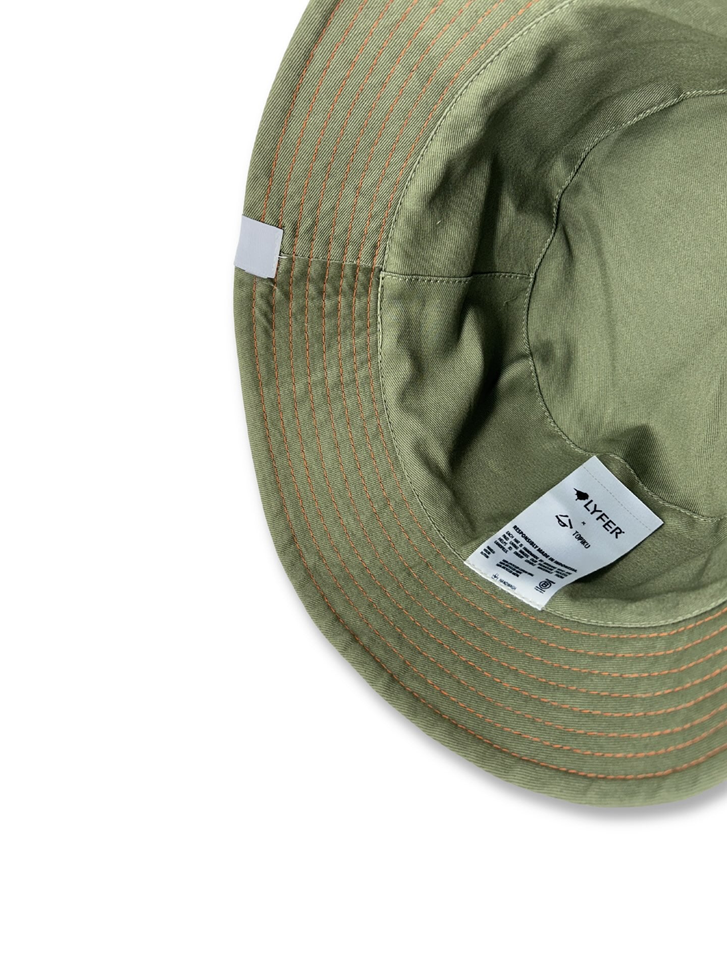 Green bucket hat with a brand label on a white background