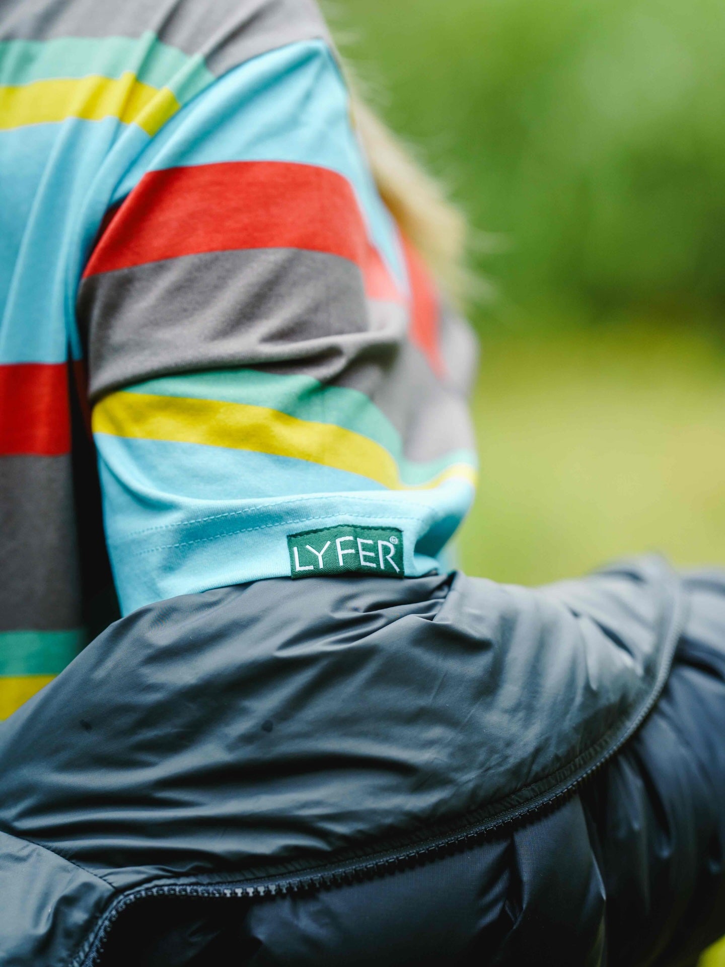 close up of the woven LYFER arm tag showing the detail of the tshirt.