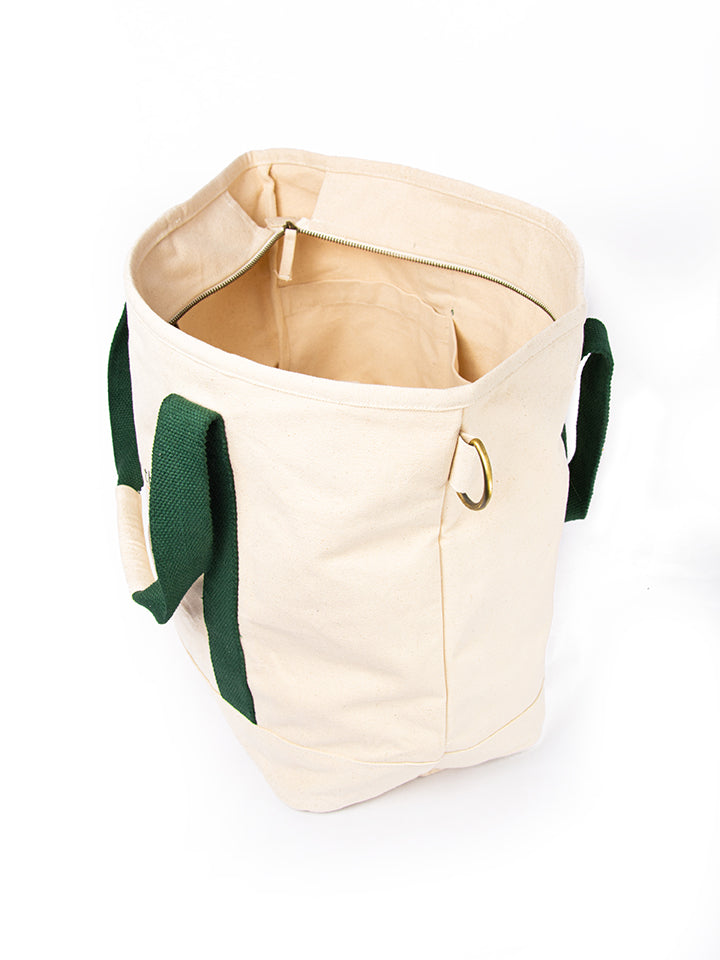 Side view of Lyfer Tote Field Bag showcasing the capacity of the bag and detailed brass holder ring.