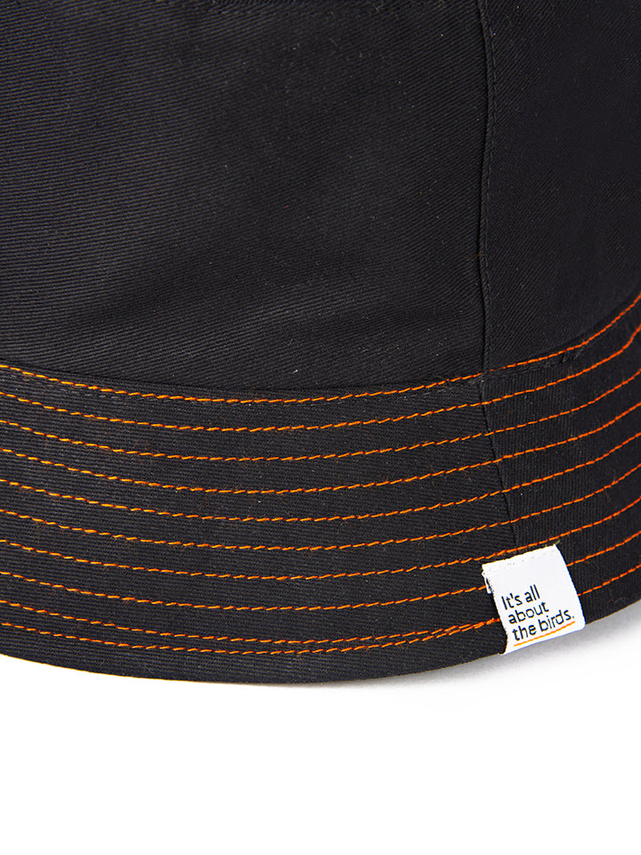Close up shot of the orange thread stitching and the Its All About the Birds woven tag. Sustainably
 and ethically made birdwatching hat is a great gift for birder in Australia.