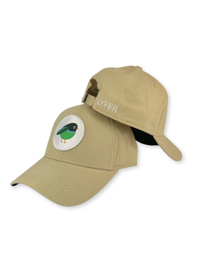 A khaki beige baseball cap with a circular patch featuring a green bird on the front, and the brand name 'LYFER' embroidered on the side. The cap is shown from a three-quarters angle against a plain white background.
