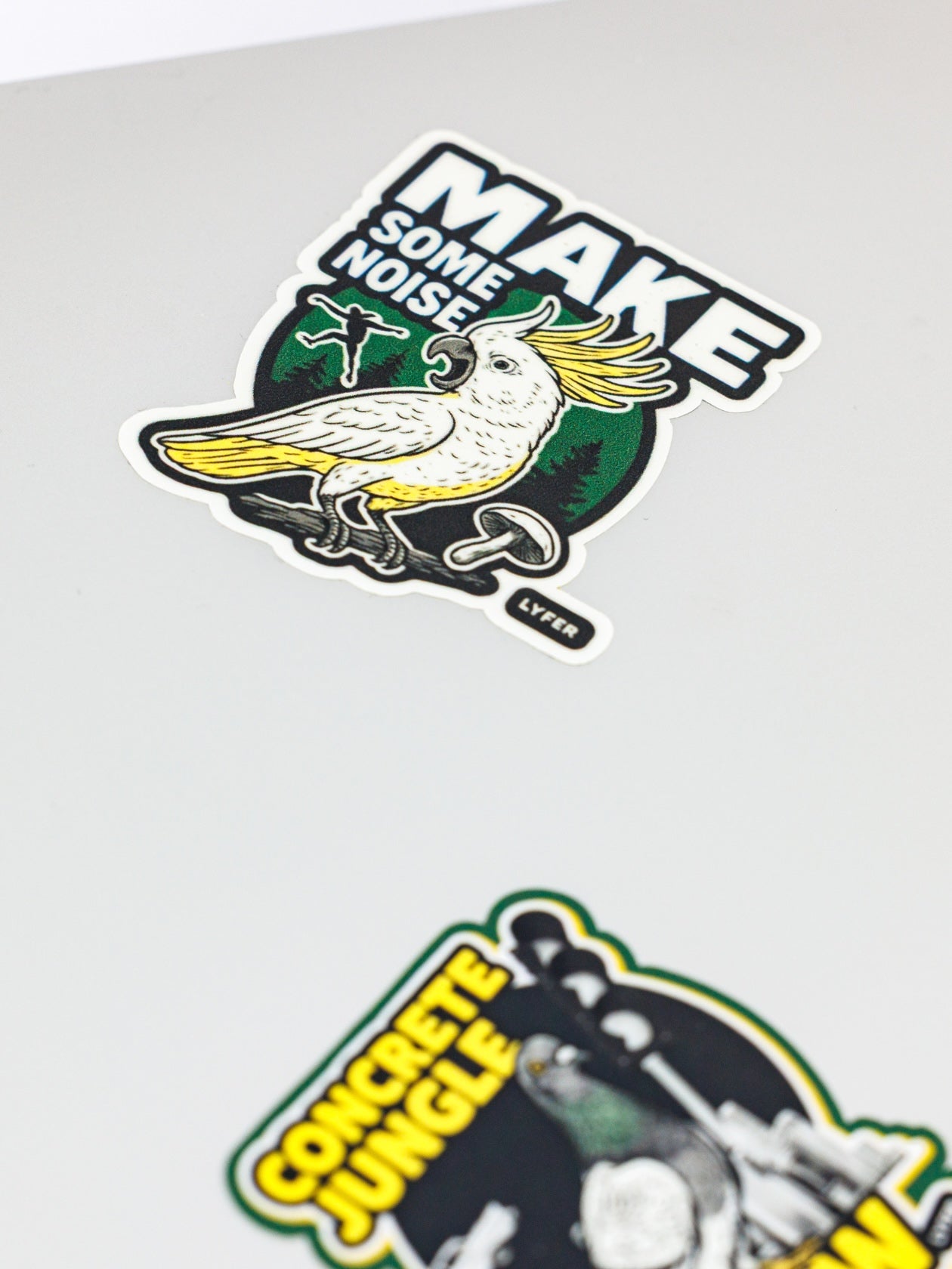 Two urban bird stickers with a bird design and text on a white background