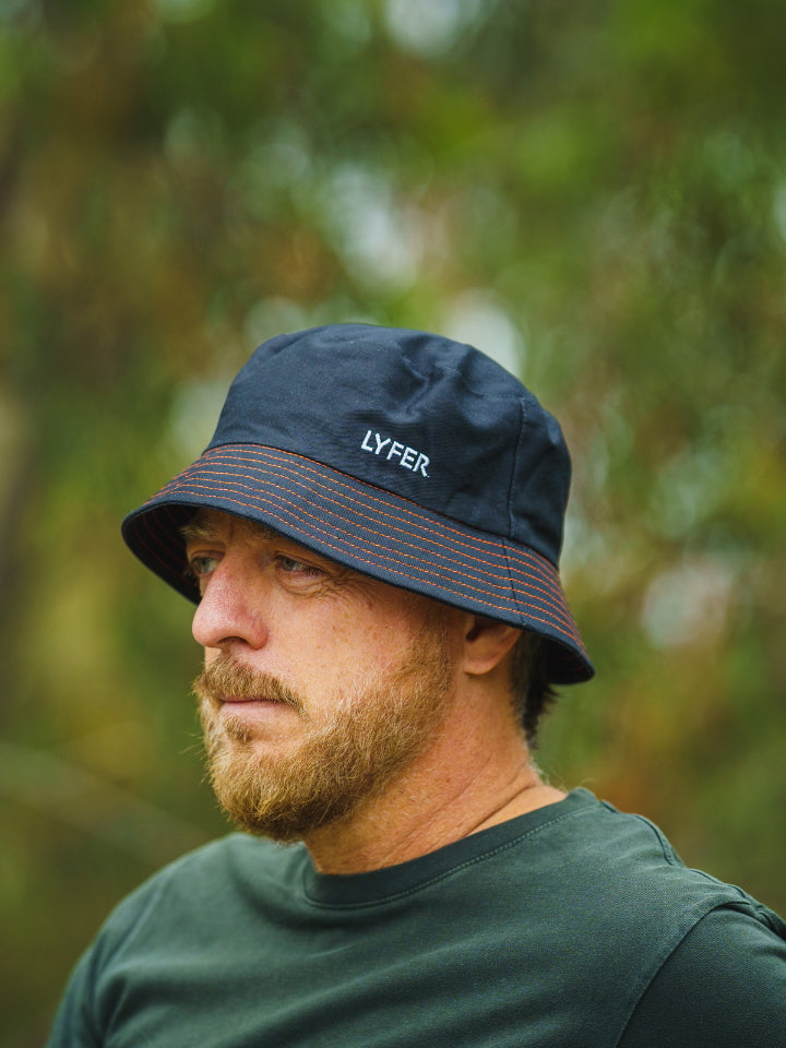 Lyfer Brand Bucket Hat in Black worn by model out in nature, sustainably
 and ethically made birdwatching hat is a great gift for birder in Australia.