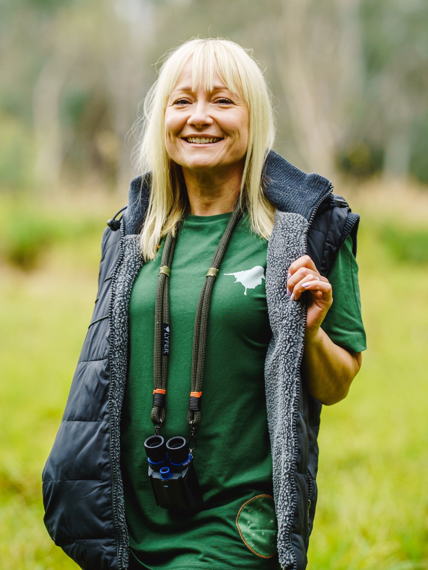 Model wearing the Lyfer BRAND tee out birding in nature.