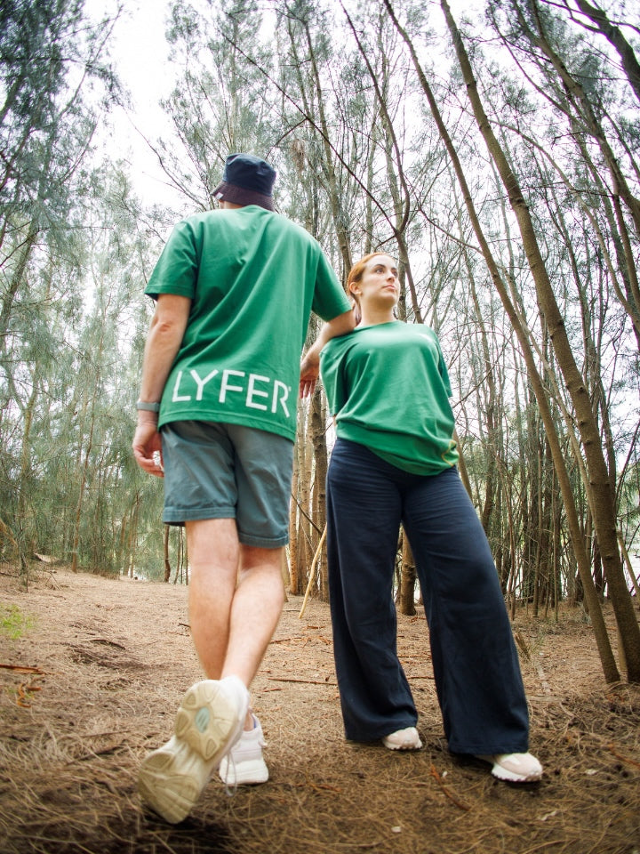 Two Models wearing Lyfer Brand Green T-shirts, out in nature showing the detail of the T-shirts. Designer birding gear for birders in Australia.