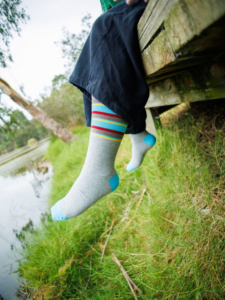 Outdoor photo of model wearing the Endangered Range casual socks in nature. Birdwatching gift bundle ideal for Australian bird lovers.