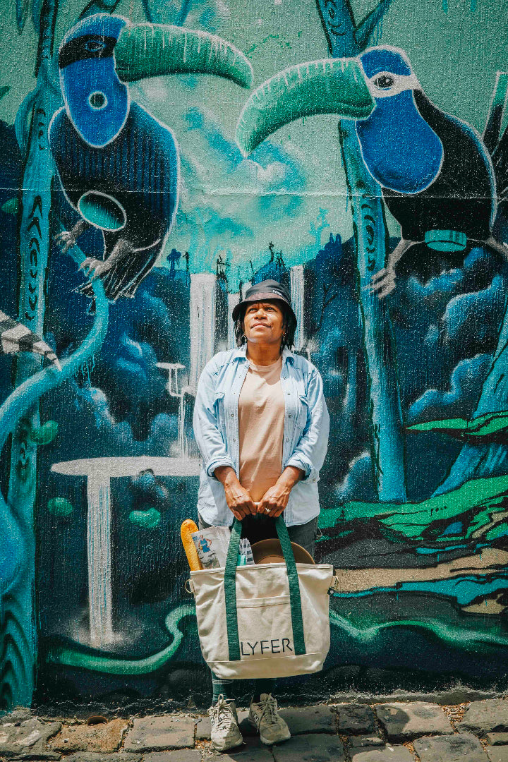 Model holding the nature tote bag, while out in an urban setting.
