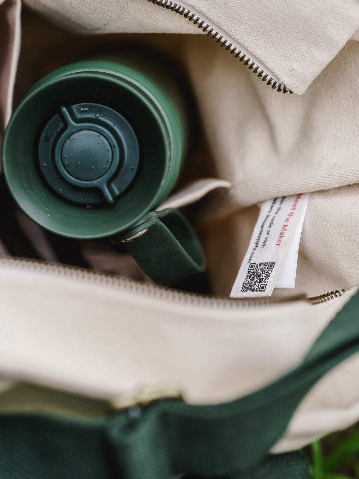 Green lyfer thermo bottle inside a LYFER tote field bag with a visible brand label of known supply QR code