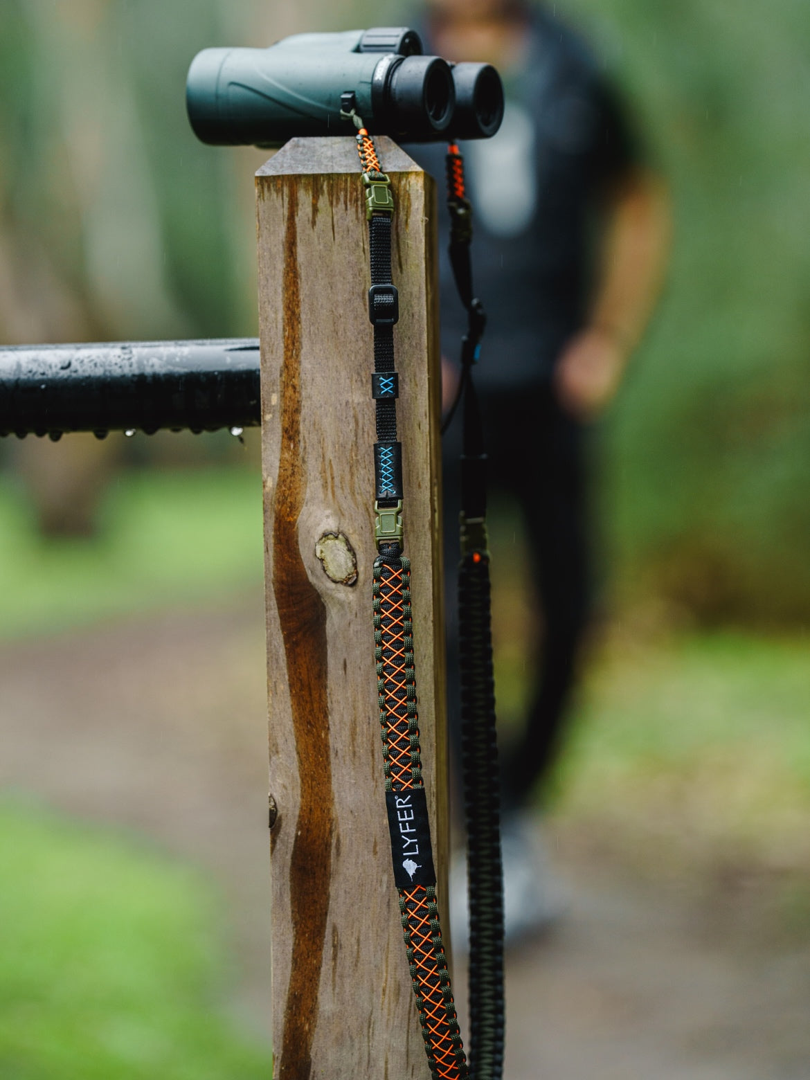 Adjustable Binocular and Camera Straps in full detail with model birder walking in background