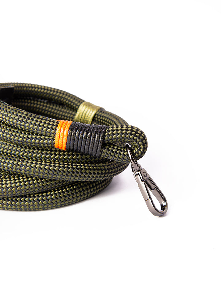 Close up shot of Lyfer's birding binocular & camera straps, showing the woven tag, thread detail and carabiner fastening clips. 