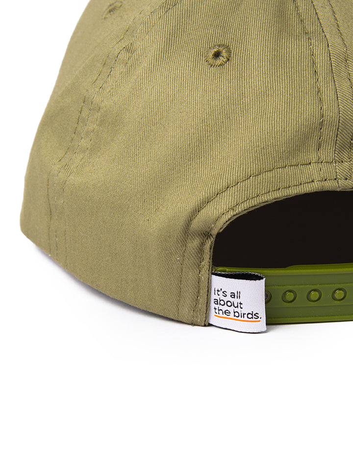 Detailed image of the Lyfer Birdmark 6-panel cap’s top, showcasing the stitching , construction and the woven tag that says Its all about the birds.