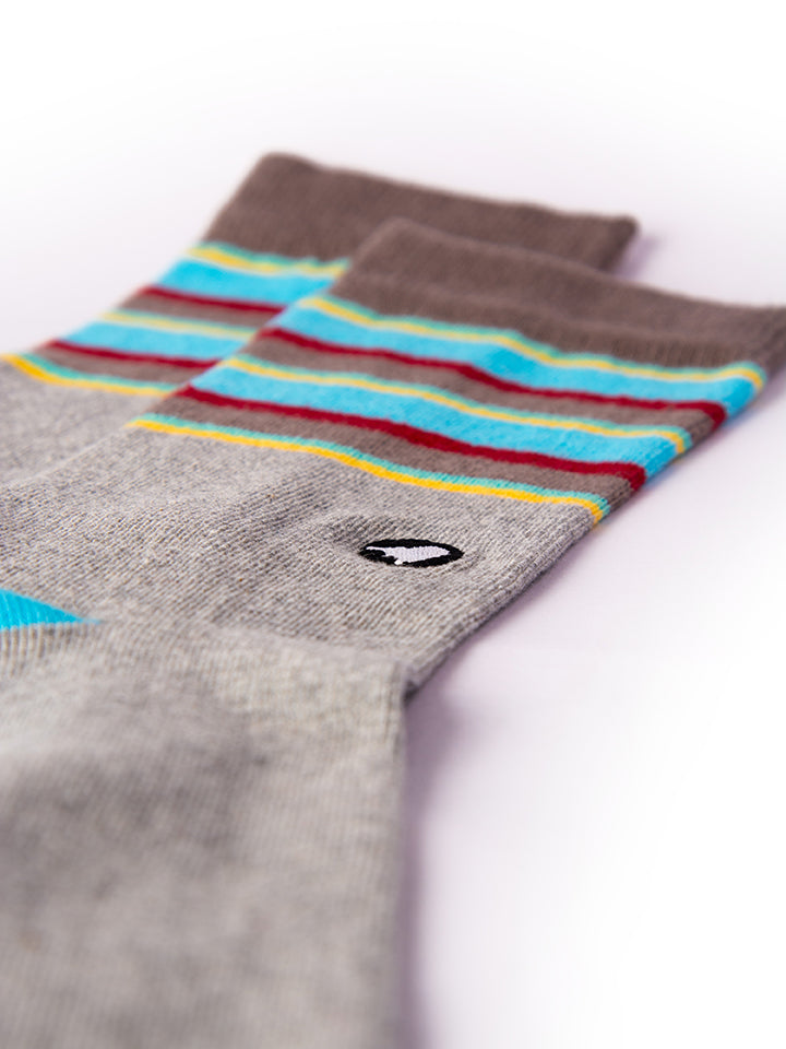 Flat-lay of the socks alongside nature elements, of these nature-inspired socks.