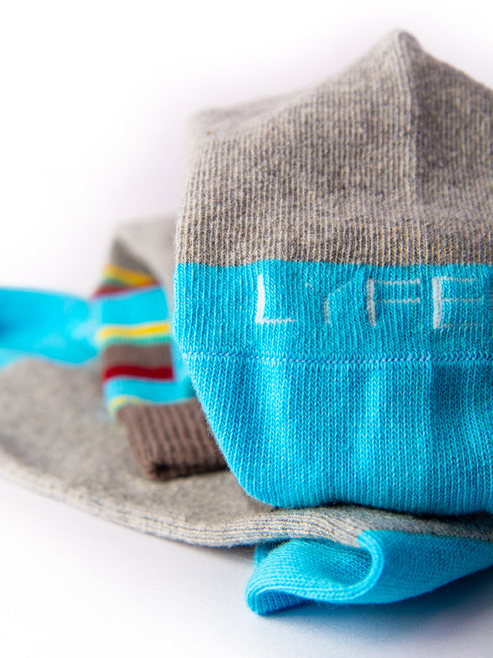 Nature-inspired socks, close-up of fabric texture and detailed stitching and toe of sock with LYFER brand.
