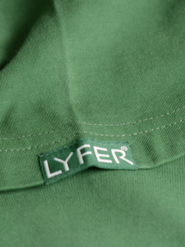 Close-up of Lyfer brand t-shirt sleeve, displaying the woven fabric tag with the brand’s LYFER on it, this is a bird lover's t-shirt.