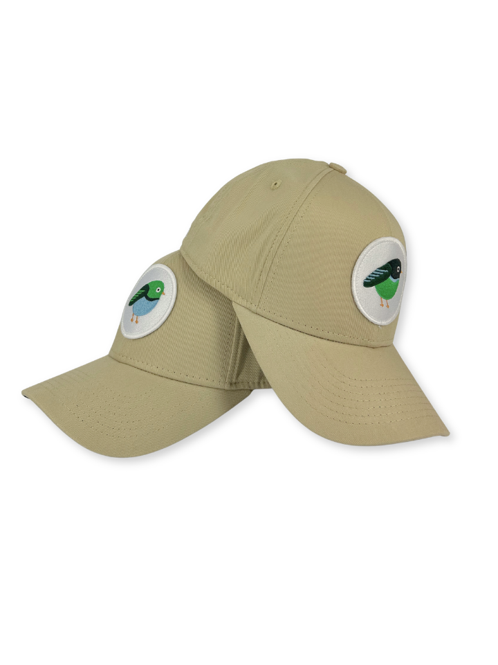 A khaki baseball cap with two circular embroidered bird patches on the front and side panels, shown against a plain white background.
