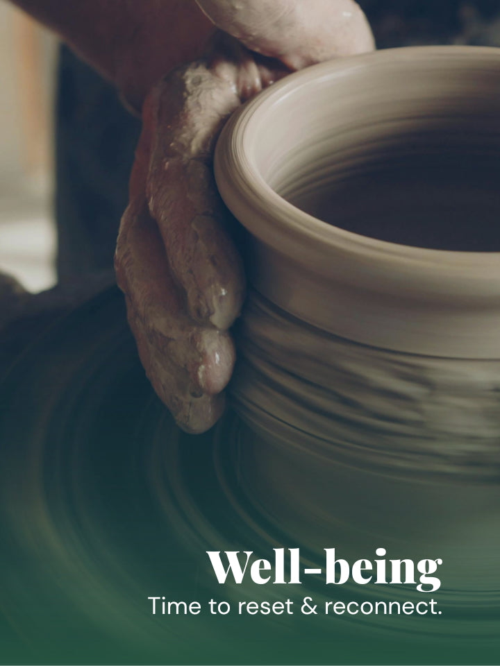 A close-up photo of a potter's hands shaping a light beige clay pot on a spinning wheel, with the text 'Well-being Time to reset & reconnect.' overlaid at the bottom.
