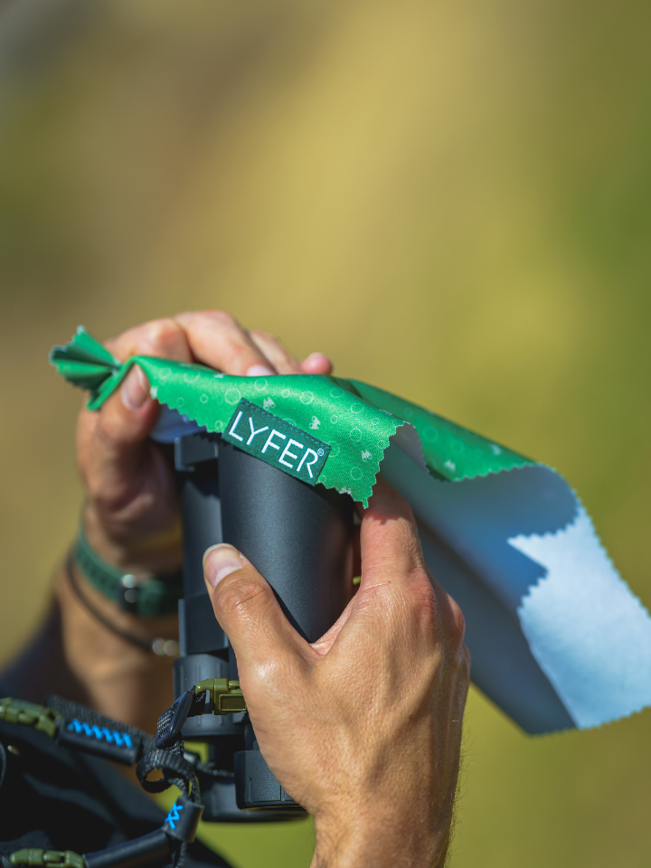 Close up Binocular and camera cleaning cloth, binoculars being cleaned