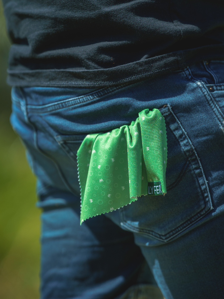 Close up Binocular and camera cleaning cloth in the back pocket of model