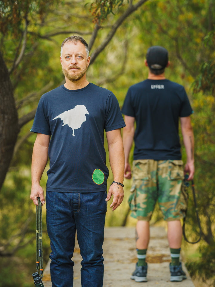 Two male models wearing the Lyfer Birdmark tshirt back to back showing the detail of the print and scale. 