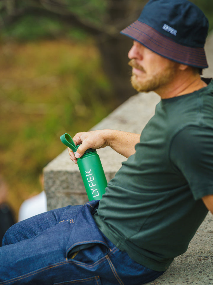 Lyfer Thermo Bottle in the hands of a model relaxing