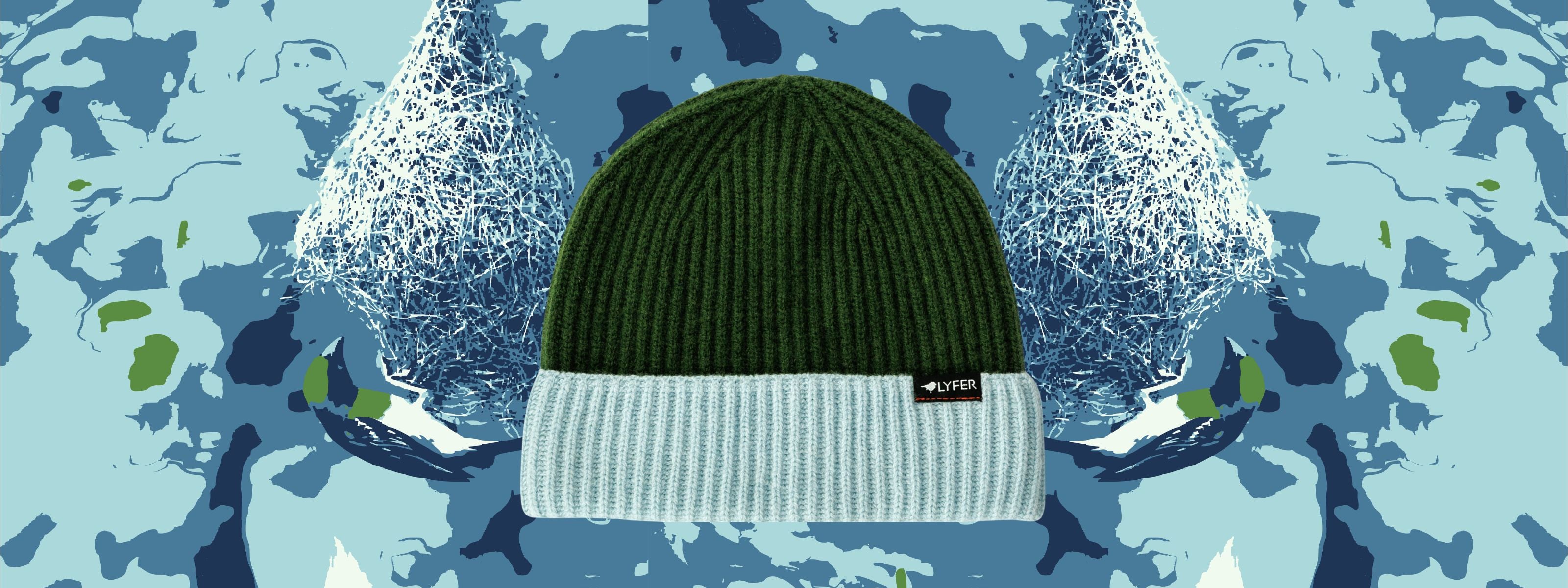 A ribbed knit beanie hat with a dark green upper section and a white lower cuff, featuring a small black label that reads 'BURLE' on the side. The hat is centered against a stylized winter-themed graphic background with blue and white snowy trees.